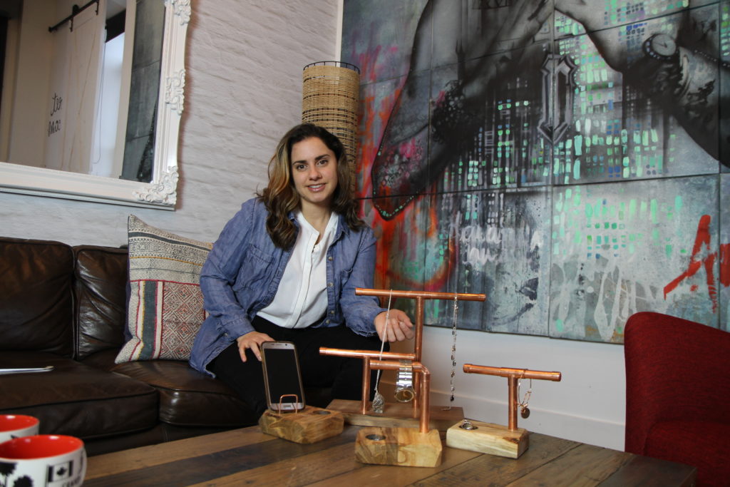 maker Lynne Adam pictured with copper pipe stands